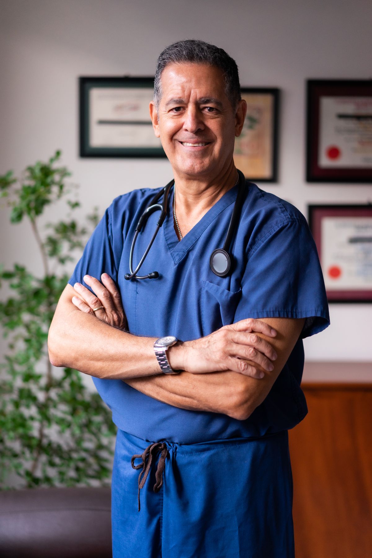 Senior clinician standing with arms crossed