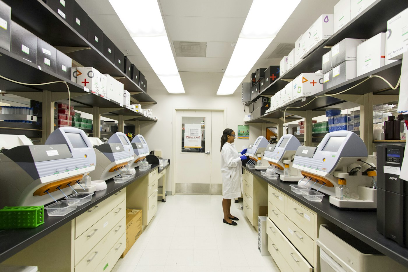 Scientist working among laboratory analyzers